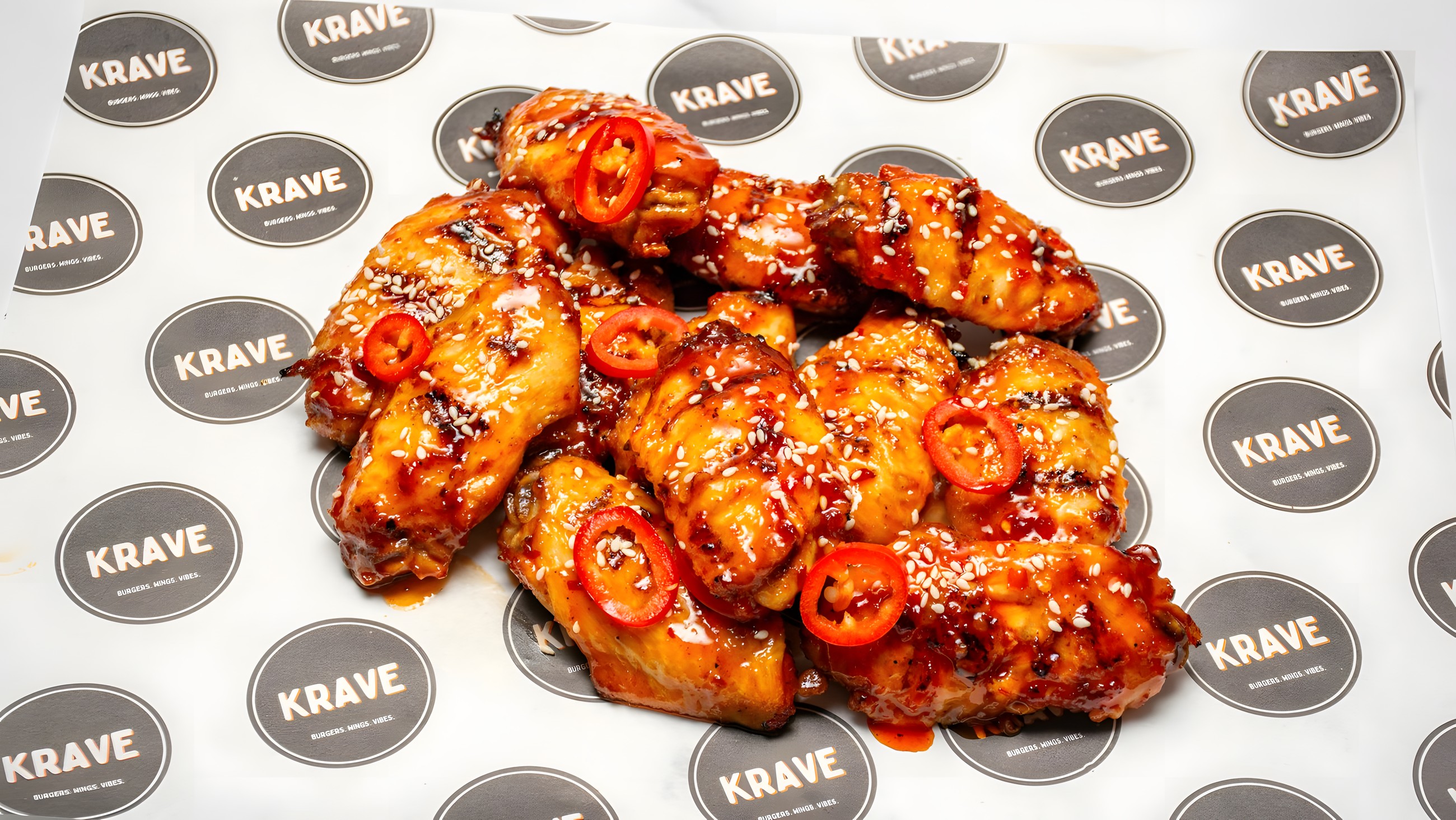 Sticky BBQ sesame wings on KRAVE branded paper